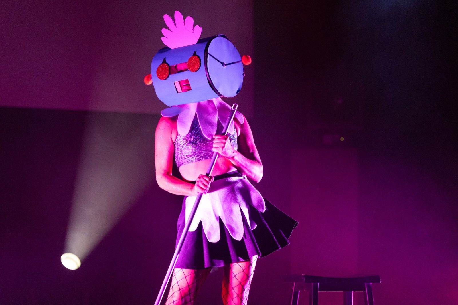 Performer wearing a playful pink-and-white handmade robot head