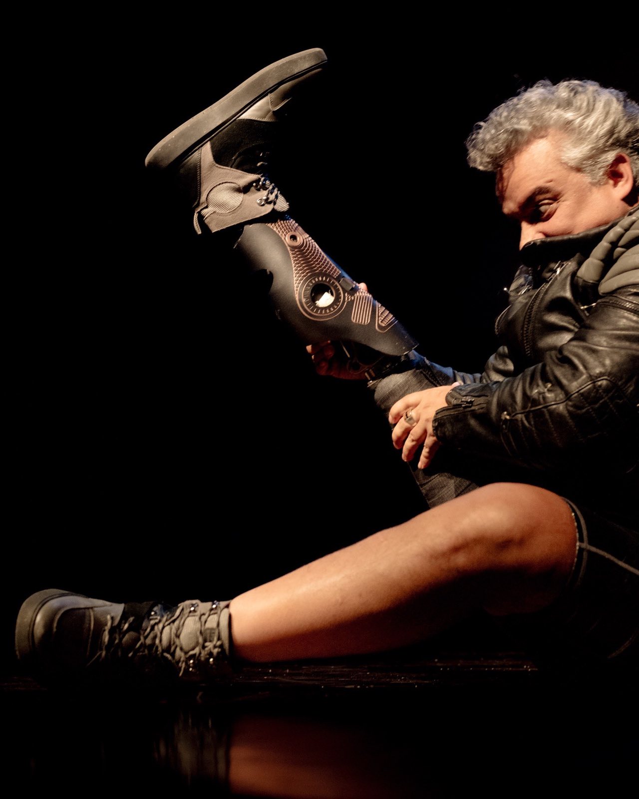 Performer presenting a reconstructed robotic body onstage