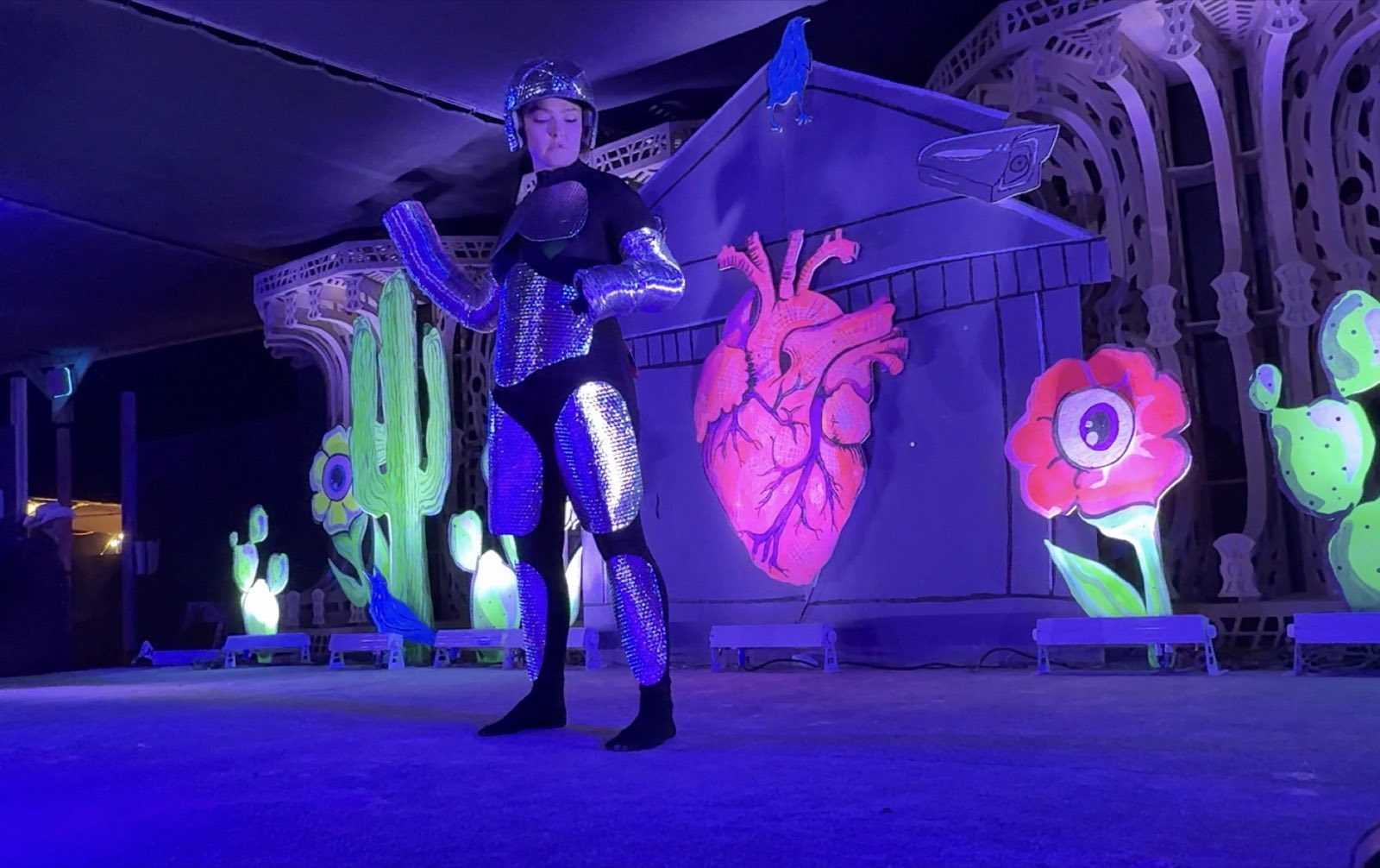 A silver-armored character performing beside the anatomical heart scenery