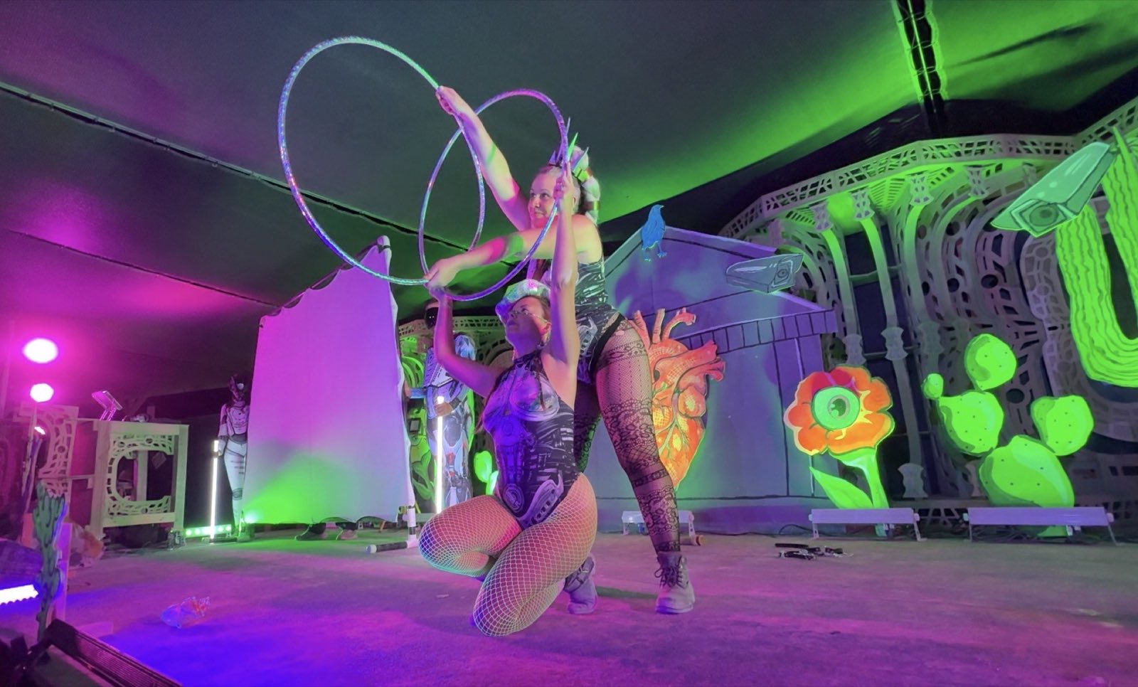 Two performers creating an interlocking hoop composition