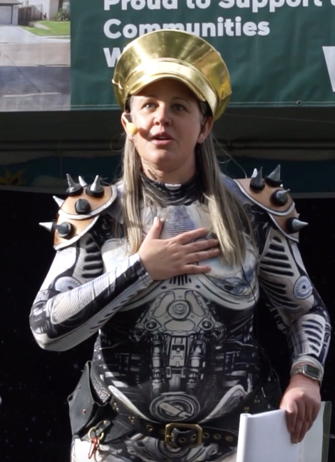Crowned robot character speaking to the festival audience