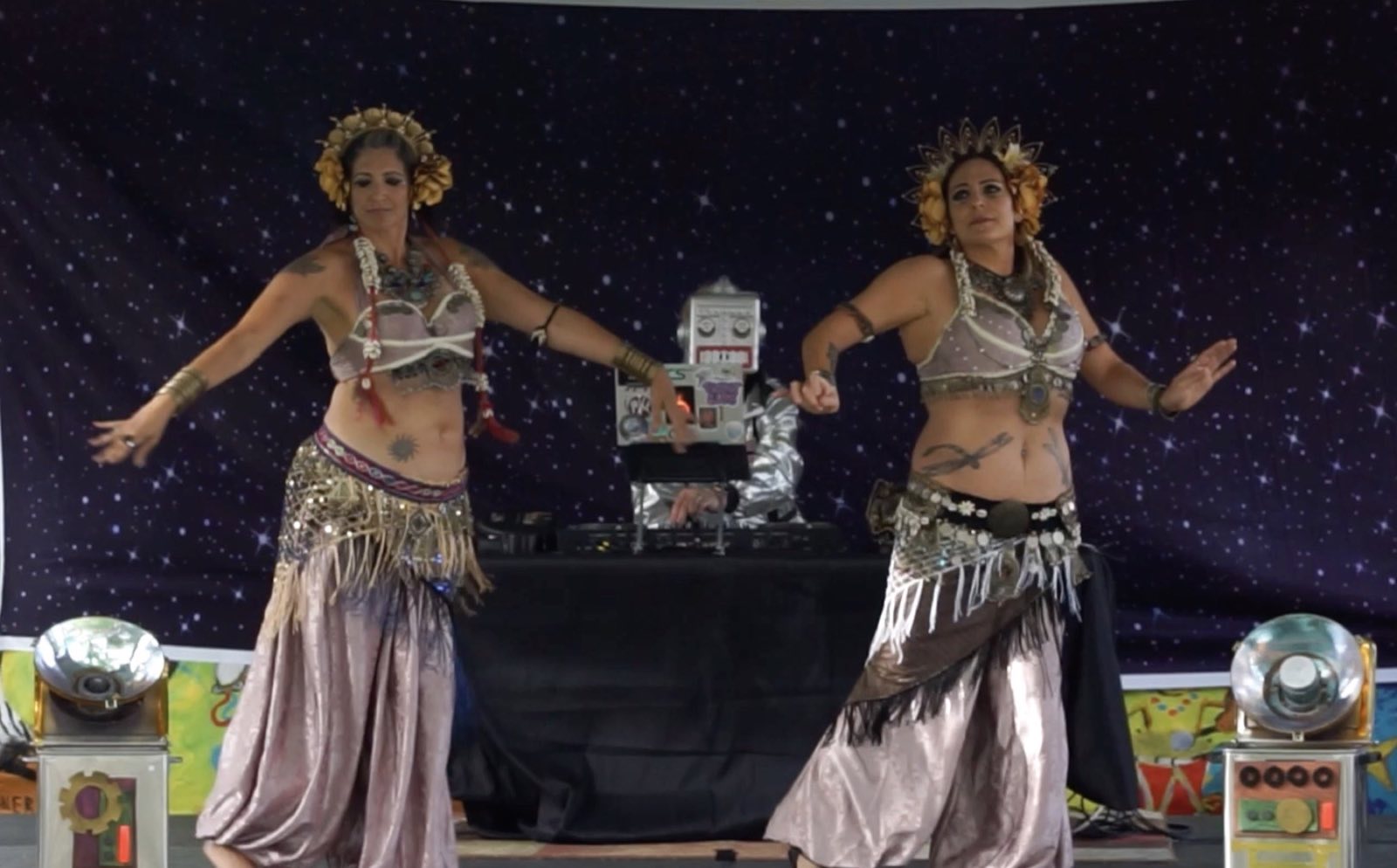 Two dancers holding hands across the festival stage