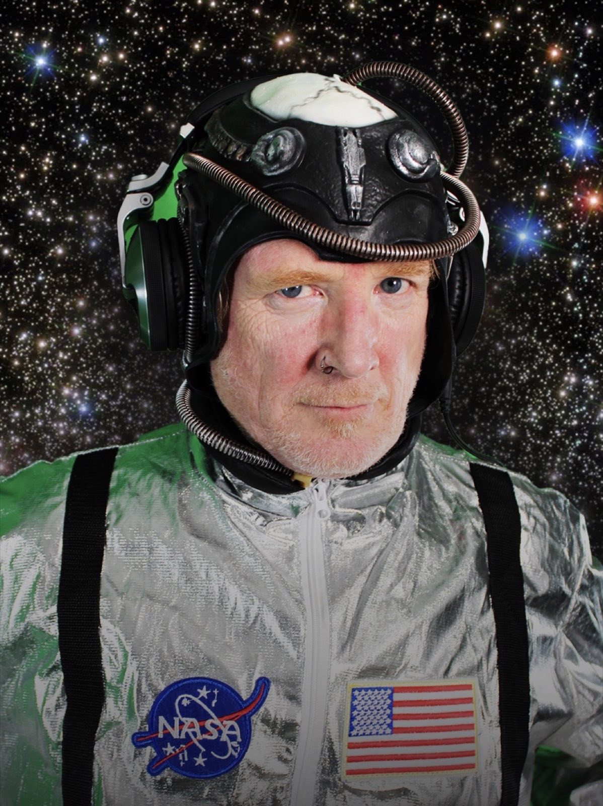 Doug Quick in a silver robot flight suit and handmade technological helmet
